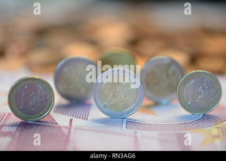 One and two Euro coins on a Euro banknote Stock Photo