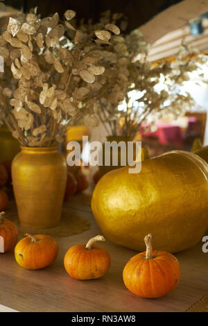 beautiful autumn composition with pumpkins. autumn cozy still life. pumpkins, autumn leaves and candles on wooden background. soft focus, top view Stock Photo