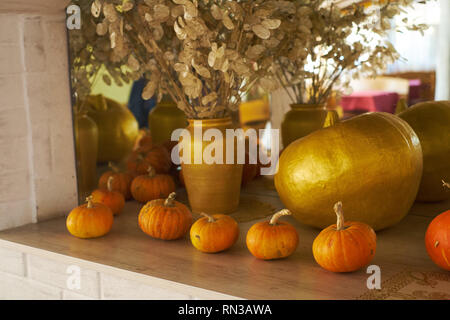 beautiful autumn composition with pumpkins. autumn cozy still life. pumpkins, autumn leaves and candles on wooden background. soft focus, top view Stock Photo