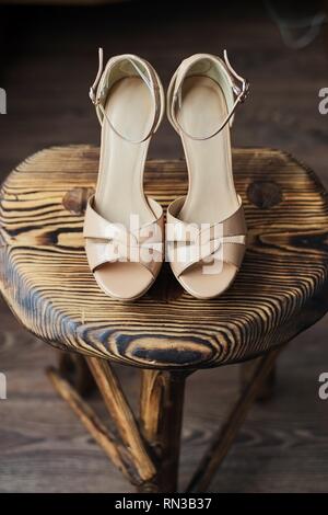 Wooden chair on it pink high-heeled sandals gently pink Stock Photo