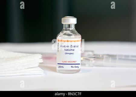 Herpes Zoster vaccine in a glass vial in a medical setting Stock Photo