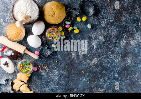 Happy Easter card. Easter biscuits,  cuttings, candy eggs and ingredients for baking rolled dough dough Stock Photo