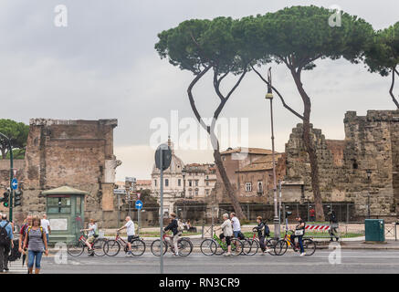 A group of cyclists on a crosswalk  in Rome city. Italy Stock Photo