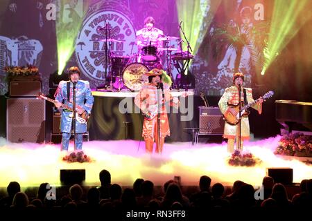 Musicians Steve Landes, Joe Bithorn, Joey Curatolo and Ralph Castelli are shown performing on stage as 'Rain' in a Beatles Tribute concert appearance. Stock Photo