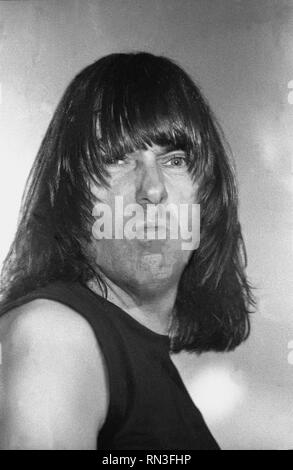 John Cummings better known by the stage name Johnny Ramone, guitarist of the punk rock band the Ramones is shown performing on stage during a 'live' concert appearance. Stock Photo