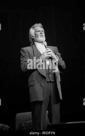 Singer Kenny Rogers is shown performing on stage during a 'live' concert appearance. Stock Photo