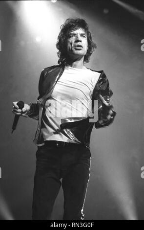 Singer Mick Jaggar is shown performing on stage during a 'live' concert appearance with the Rolling Stones. Stock Photo