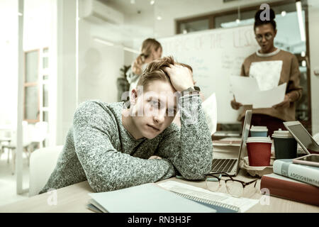 Postgraduate student feeling like outcast in his new class Stock Photo