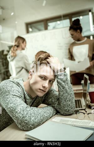 Handsome student feeling isolated and lonely in the class Stock Photo