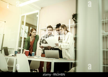 Students having interesting class with their helpful teacher Stock Photo