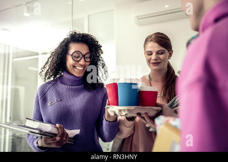 Cheerful student in glasses feeling excited before coffee break Stock Photo