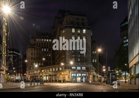 London, England, UK - December 17, 2018: St James's Park tube station and 55 Broadway, the art deco headquarters of London Underground, is lit at nigh Stock Photo