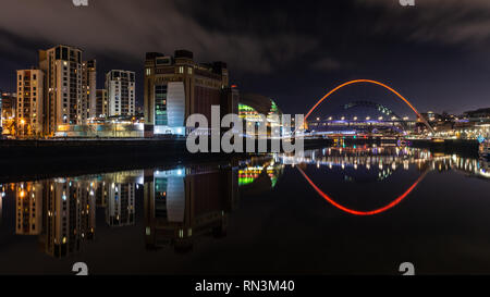 Gateshead, England, UK - February 3, 2019: The Baltic Flour Mills, Sage Gateshead and modern apartment buildings are reflected in the River Tyne at ni Stock Photo