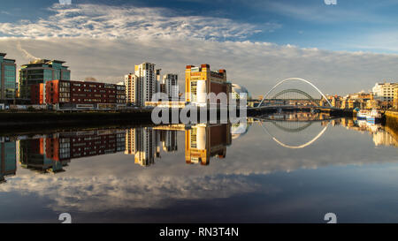 Gateshead, England, UK - February 5, 2019:  Dawn light falls on the iconic Baltic Flour Mills building, Tyne Bridge and Gateshead Millennium Bridge on Stock Photo