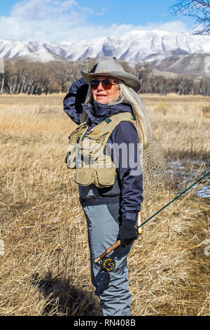 Caucasian Cowboy Fly Fishing In A Mountain Lake Stock Photo - Alamy