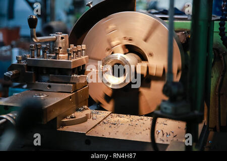 CNC lathe processes metal detail. Automated production. Stock Photo