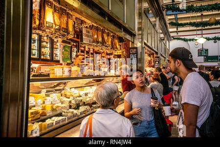 3rd January 2019, Melbourne Victoria Australia : People drinking coffee in front of a cheese shop inside Queen Victoria Market aisle in Melbourne Aust Stock Photo