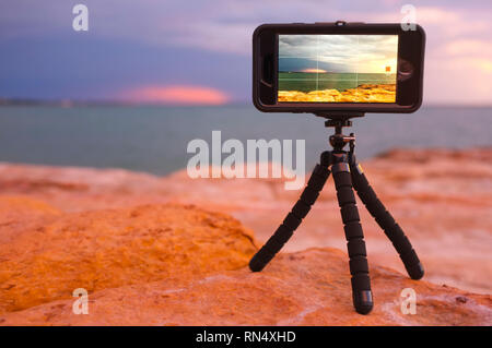 Mobile phone on a mini tripod recording a time lapse at East Point in Darwin, Northern Territory, Australia. Stock Photo