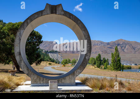 The view of Benmore Dam through a section of a large concrete pipe that stands near the entrance in the Waitaki Valley, New Zealand Stock Photo