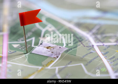 Travel concept: a red flag pushpin on a location of a destination point on a map Stock Photo