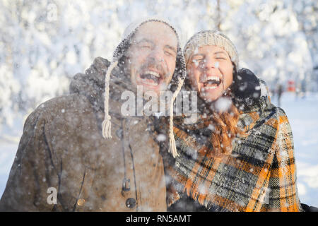 Couple Enjoying Snowfall Stock Photo