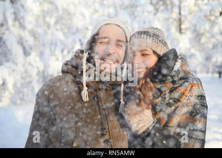 Loving Couple Enjoying Snowfall Stock Photo