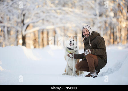 Man Posing with Akita Dog Stock Photo