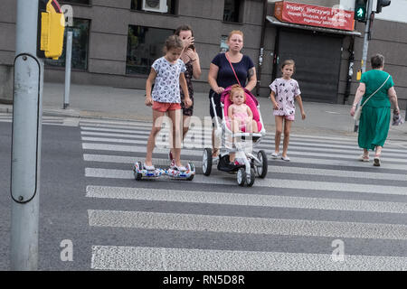 female family members crossing the road on a zebra crossing Stock Photo