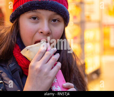 Asian American girl eating crepe Stock Photo