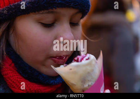 Asian American girl eating crepe Stock Photo