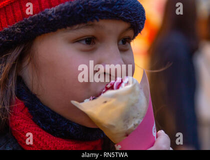 Asian American girl eating crepe Stock Photo