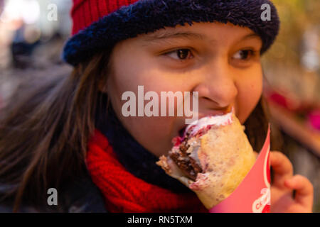 Asian American girl eating crepe Stock Photo