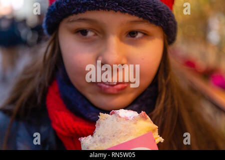 Asian American girl eating crepe Stock Photo