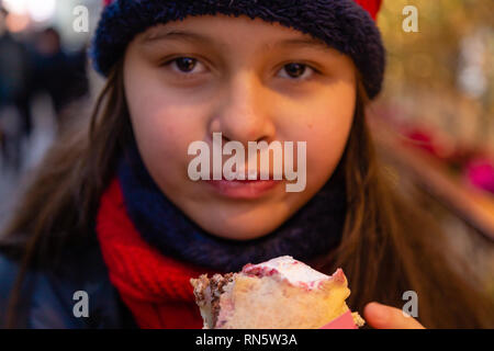 Asian American girl eating crepe Stock Photo