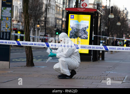 London, UK. 17th Feb 2019. A forensic team take swabs of blood, measurements and remove evidence after 3 men were stabbed. A fight broke out outside Tape nightclub in Mayfair in the early hours of the morning. Two men have been arrested on suspicion of attempted murder. Triple stabbing near Oxford Street, London. Credit: Tommy London/Alamy Live News Stock Photo