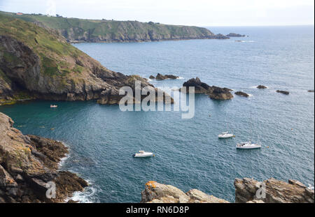 Three Small Boats Moored in La Havre Gosselin Harbour Between the Little Island of Brecqhou and Sark on the Island of Sark, Channel Islands, UK. Stock Photo