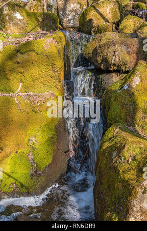 Falling water among rocks Stock Photo