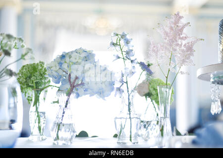 A beautiful Wedding table set up with soft pastel coloured flowers and antique French glasswear - it is soft, elegant and aspirational Stock Photo