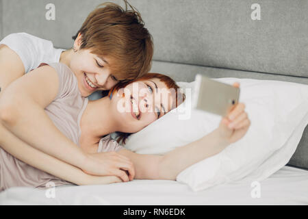 cheerful girls having fun with a mobile phone, happiness, positive emotions. close up photo. copy space Stock Photo