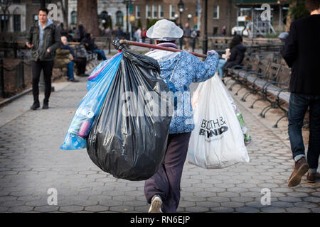 A middle aged Asian woman collecting deposit bottles in Greenwich Village, New York City. Stock Photo