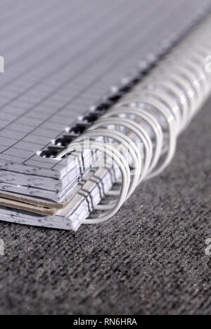 Open notepad with spring-bound binding closeup. Shallow depth of field Stock Photo