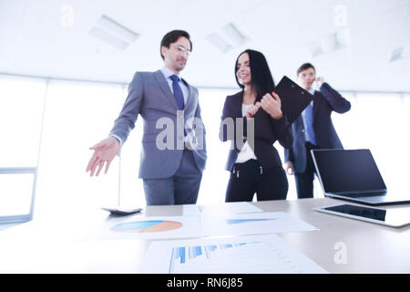 Business people discussing financial reports in office Stock Photo