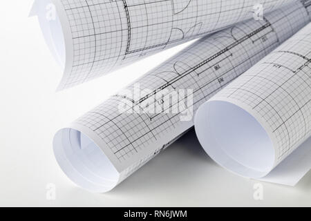 Rolls of architectural blueprint house building plans on white table background Stock Photo