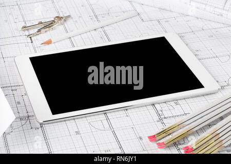 Tablet pc architectural blueprint house building plan with pencil, compasses and folding rule Stock Photo