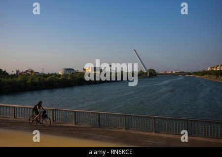 The Guadalquivir river, the fifth longest river of the Iberian Penisula, cuts through the city of Seville, Spain. Stock Photo