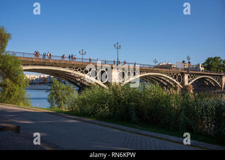 The Guadalquivir river, the fifth longest river of the Iberian Penisula, cuts through the city of Seville, Spain. Stock Photo