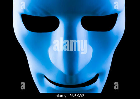 Blue face mask artificial intelligence concept close up on a black background Stock Photo