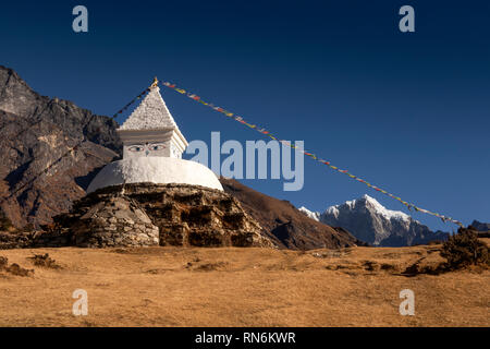 Nepal, Namche Bazaar, elevated white painted chorten with all seeing eyes and prayer flags Stock Photo