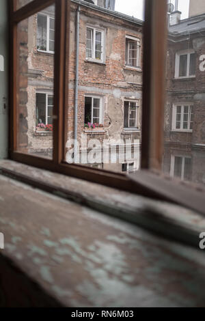 flowers in a window box in an old tenement house Stock Photo