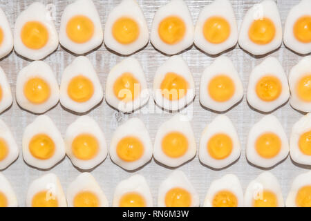 candy fried eggs shaped on a light wooden background Stock Photo